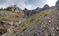 Looking back up at the headwall. Treed ramps at left, hard routes in between and part of our gully just barely visible at upper right.