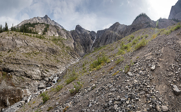 Looking back up at the headwall. Treed ramps at left, hard routes in between and part of our gully just barely visible at upper right.