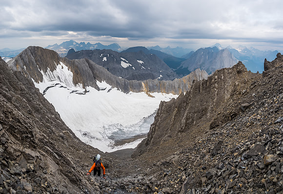 Continuing as high as possible in the slabby gully to find another scree gully running to the summit.