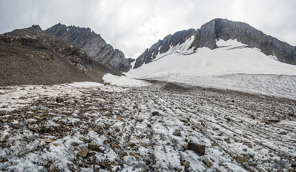 Finally the bottom of our access gully comes into view ahead and to the left in front of the far grey rock and gullies. Kane's abutment ridge at upper left.