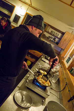 Kelly fries up the potatoes and carrots.