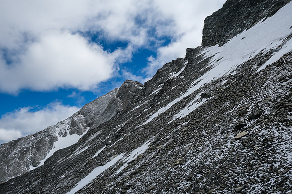 Starting up the ledge, sticking to snow as much as possible.