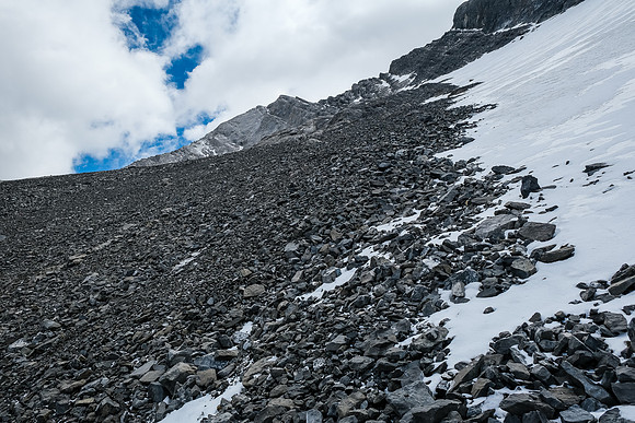 Starting up the ledge, sticking to snow as much as possible.