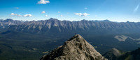 Harvey tops out to a level section on the ridge with the Elk Pass region spread out beneath him.