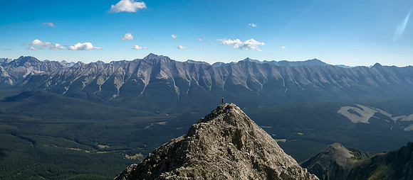Harvey tops out to a level section on the ridge with the Elk Pass region spread out beneath him.