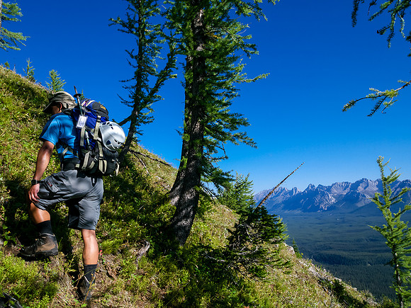 Harvey on the steeply grassed slopes beneath the start of the scrambling ridge.