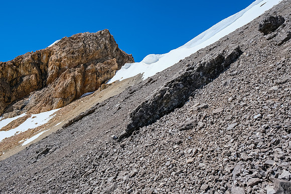 Out of danger, looking up at the cornices which unfortunately threatened our route.