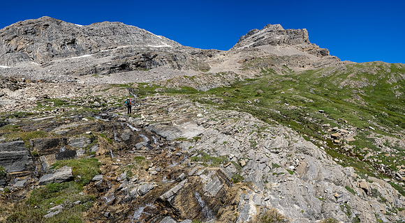 Ascending grassy ledges to the valley leading to Mount Augusta.