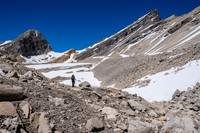Traversing a narrow alpine valley towards Mount Augusta. Our access slopes above Phil's head.