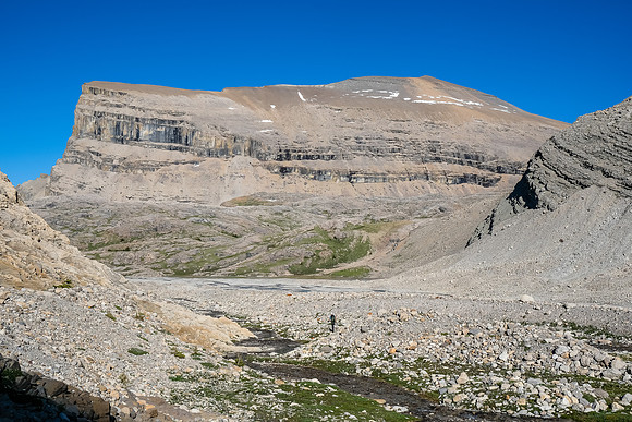 Phil traverses under Mount Harris back to our bivy.