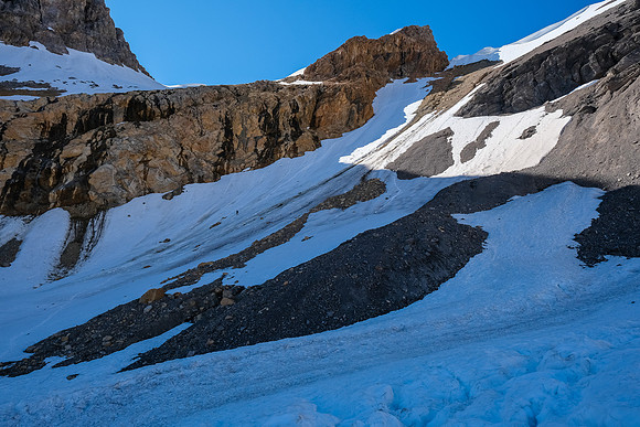 Phil is a tiny dot on the huge snow slope leading to the scree ledges above.