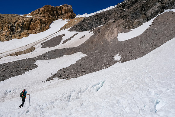 Phil approaches the bottom of the steep snow slope we used to access the scree ledges.
