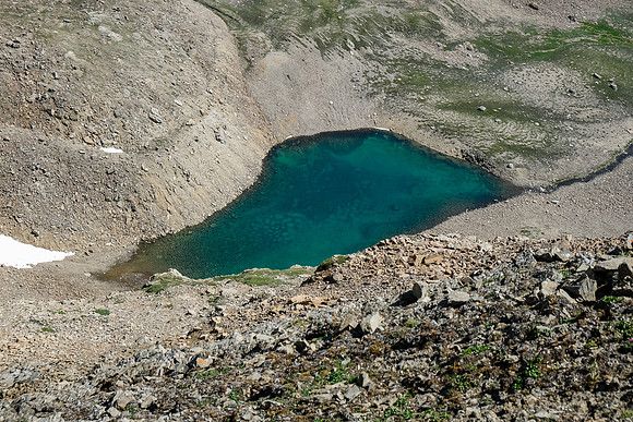 A tarn tucked under our ascent ridge.