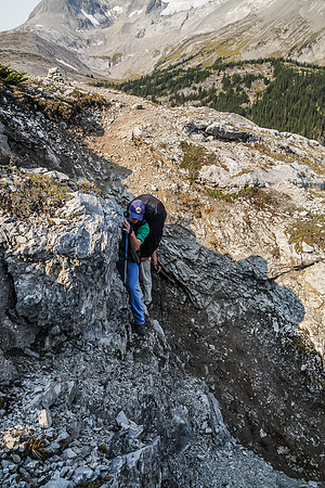 Rod delicately balances over a moderate scrambling section of the headwall. This is tricky with a large backpack on.