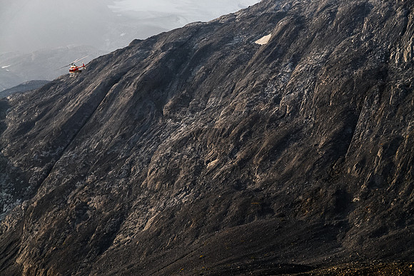 The chopper flies past Warrior's north face.