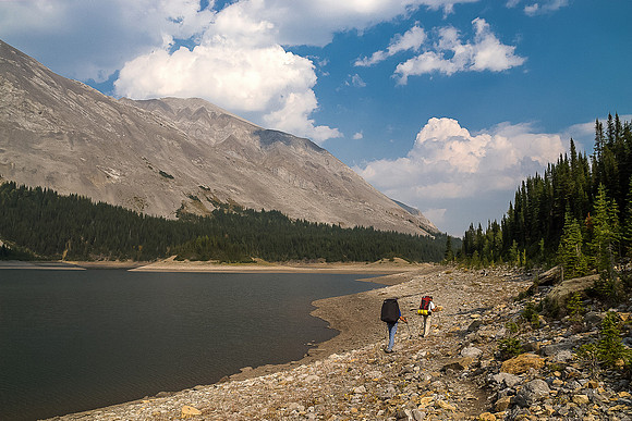 Hiking along Three Isle Lake to our campsite which is located on the left side in the distance around the shoreline. Mount Putnik rises on the left.