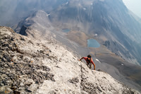 Unbelievable exposure down the SW face of Northover as Jon clambers up the crack that I found, leading to the summit. Northover Lakes far below.