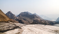 Rod comes up the glacier behind me, Aster Lake visible at far right and Kananaskis Lake in the distance.