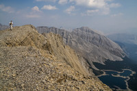 Jon takes the final few steps to the summit of Worthington with Three Isle Lake far below and Mount Putnik right of center.