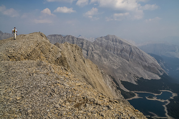 Jon takes the final few steps to the summit of Worthington with Three Isle Lake far below and Mount Putnik right of center.