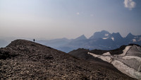 Rod ascends along the summit ridge of Worthington with McHarg at far right and the Royal Group in the distance.