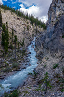 Cliffs on the right and a raging, deep torrent on the left.