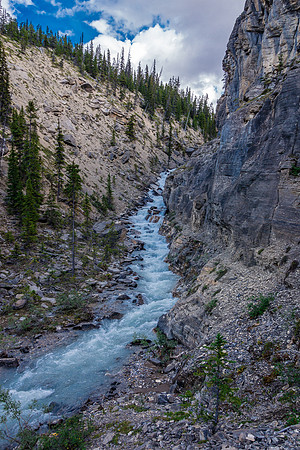 Cliffs on the right and a raging, deep torrent on the left.