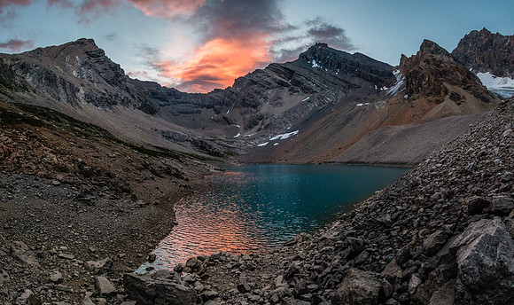 Recondite (L) and Augusta (R) reflect in the alpine tarn near our bivy site.
