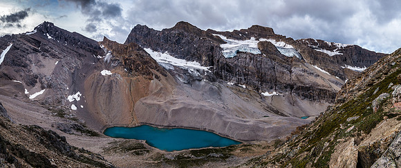 Gloomy skies looking back down at the tarn near our bivy with Augusta rising at left.