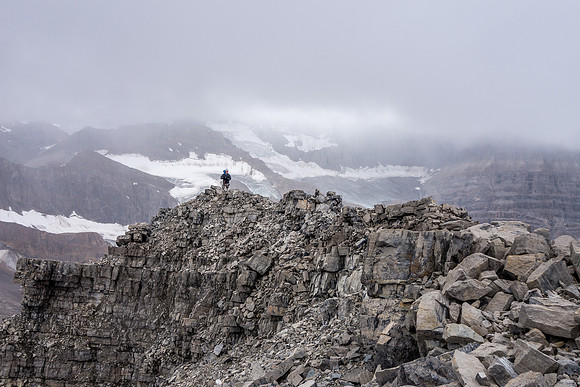 Ben takes in the wild scenery at the summit of Recondite Peak.