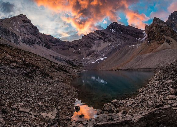 Recondite (L) and Augusta (R) reflect in the alpine tarn near our bivy site.