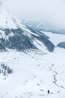 Ben is the only color showing up in the bleak morning landscape as we trudge up the moraine with our skis on our backs