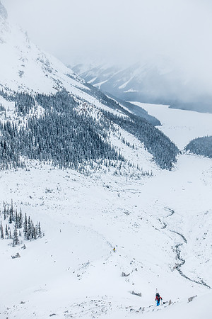 Ben is the only color showing up in the bleak morning landscape as we trudge up the moraine with our skis on our backs