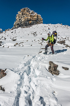Descending sunny, warm slopes with that warm after-buzz of a successful summit.