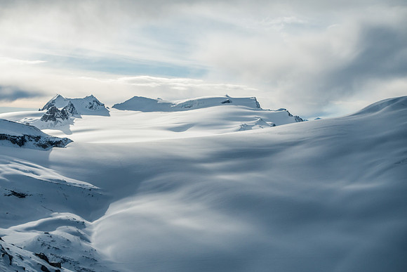 Looking back over an ocean of snow and ice at St. Nich, Olive and Gordon.