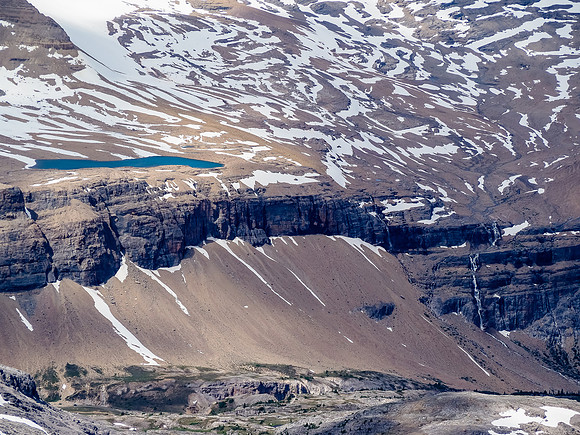 Pocket glaciers off of Cirque Peak fill this tarn before flowing over impressive walls of rock down to Dolomite Creek and eventually into Isabella Lake.