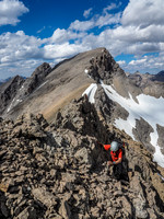 Working the loose, exposed east face terrain.