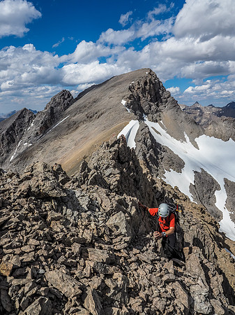 Working the loose, exposed east face terrain.