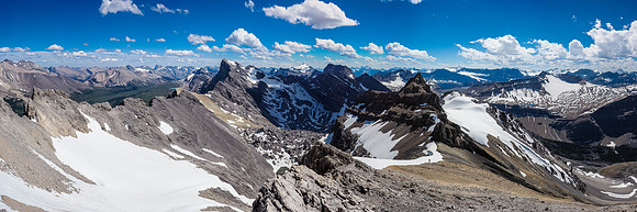 Note the difficult terrain of the south ridge behind Phil and the exposed snow / scree ledge traverse running off parallel to it at left.