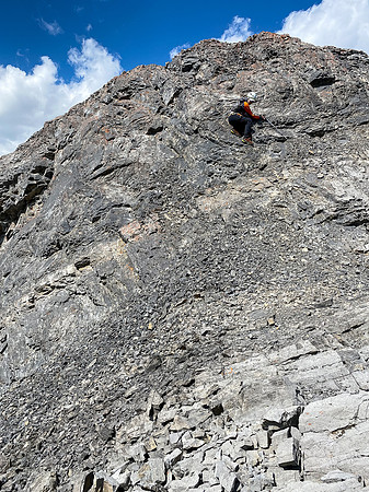 Downclimbing the outward flaring, loose, exposed crux.