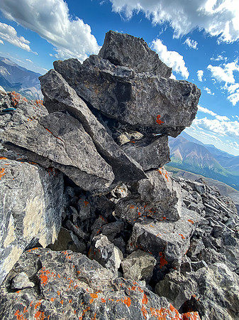 No register and the summit cairn is split open.