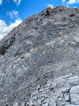 Downclimbing the outward flaring, loose, exposed crux.