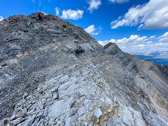 Downclimbing the outward flaring, loose, exposed crux.