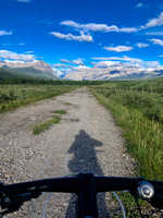 Biking through Ya Ha Tinda towards a distant Warden Rock and the Banff Park boundary.