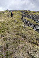 Ascending easy grassy west slopes to the false summit.