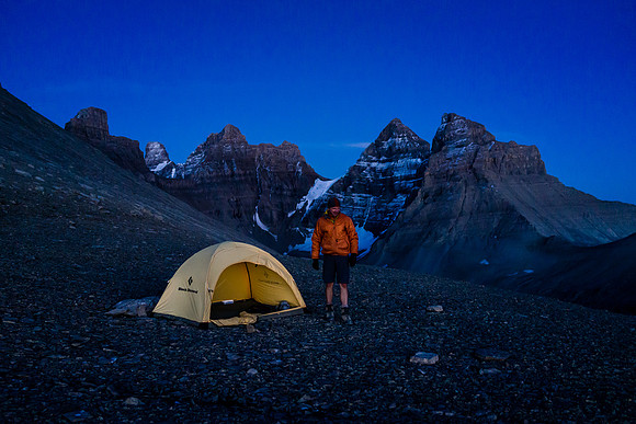 Raf gathers rocks to ensure his tent doesn't blow away. The west shoulder is fully exposed to the elements.