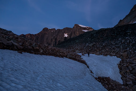 Scott approaches the col beneath the east ridge after ascending a steep snow slope on crampons.