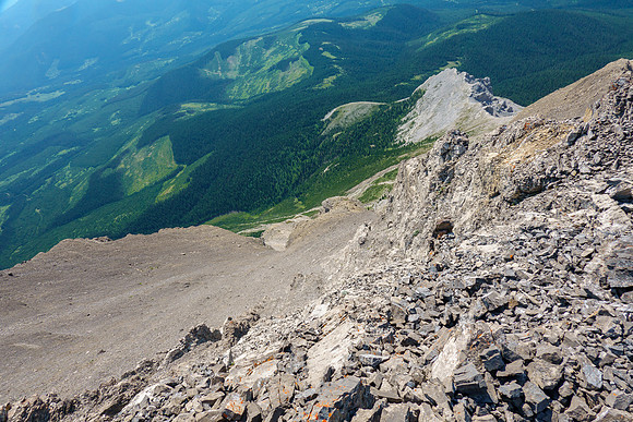 Views down the east face to the west access drainage and crux opening.