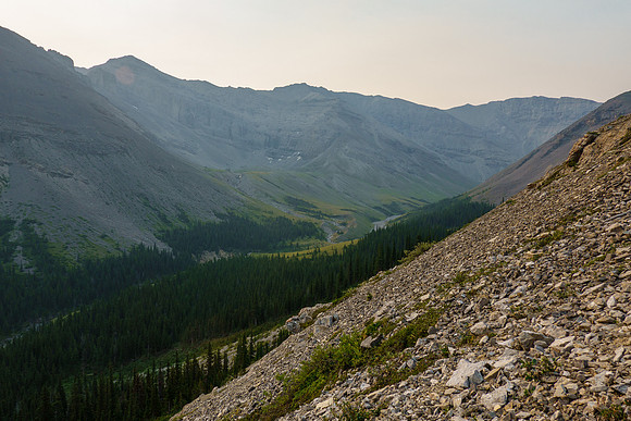 Scrambling up loose scree and rock above North Burnt Timber Creek on the NE ridge.