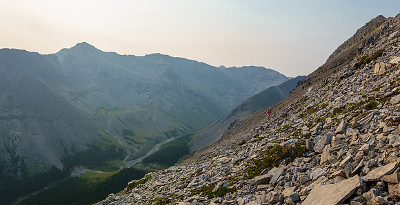 Scrambling up loose scree and rock above North Burnt Timber Creek on the NE ridge.